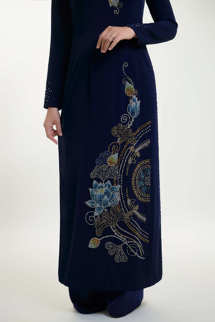 Hand-beaded Ao Dai featuring intricate lotus and Trong Dong designs, showcasing traditional Vietnamese craftsmanship.