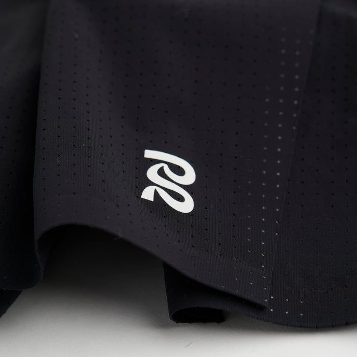 Close-up view of the Vento™ 5" Men's Training Short, highlighting the reflective logo on the front of the shorts and the micro-perforations in the fabric.