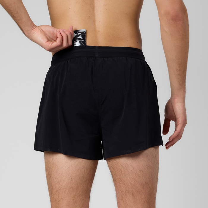 Back view of the Vento™ 3" Split Short, featuring 4 gel-sized pockets with hand shown removing a gel packet from 1 of the 4 gel-sized pockets.
